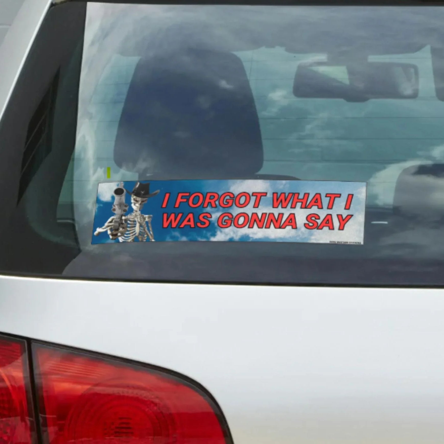 Funny weatherproof vinyl bumper sticker on car with cowboy skeletons and red text 'I forgot what I was gonna say'.