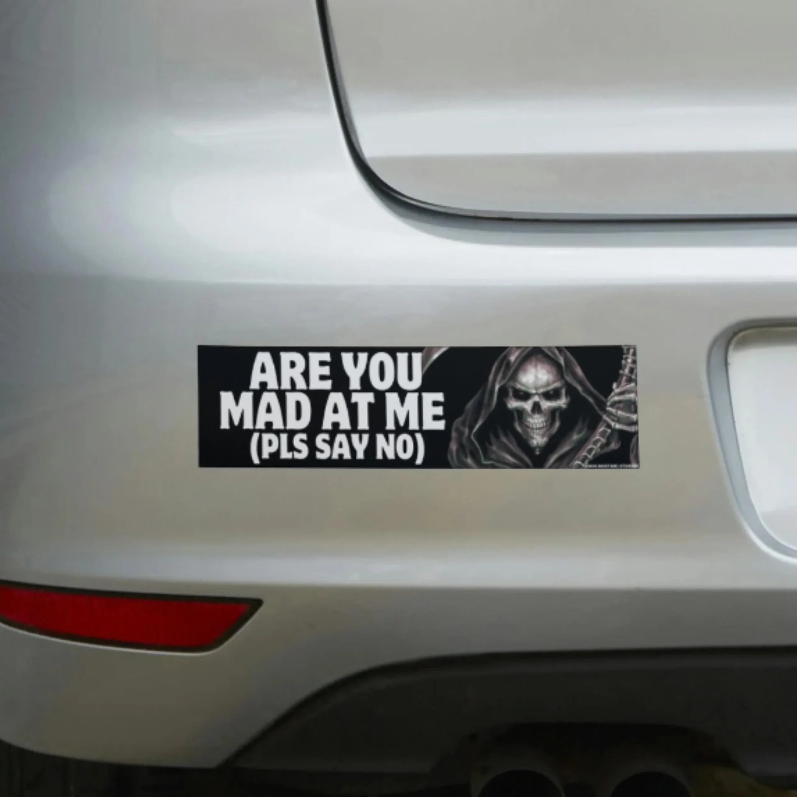 Funny bumper sticker with grim reaper saying 'Are You Mad At Me (Pls Say No)' on white car