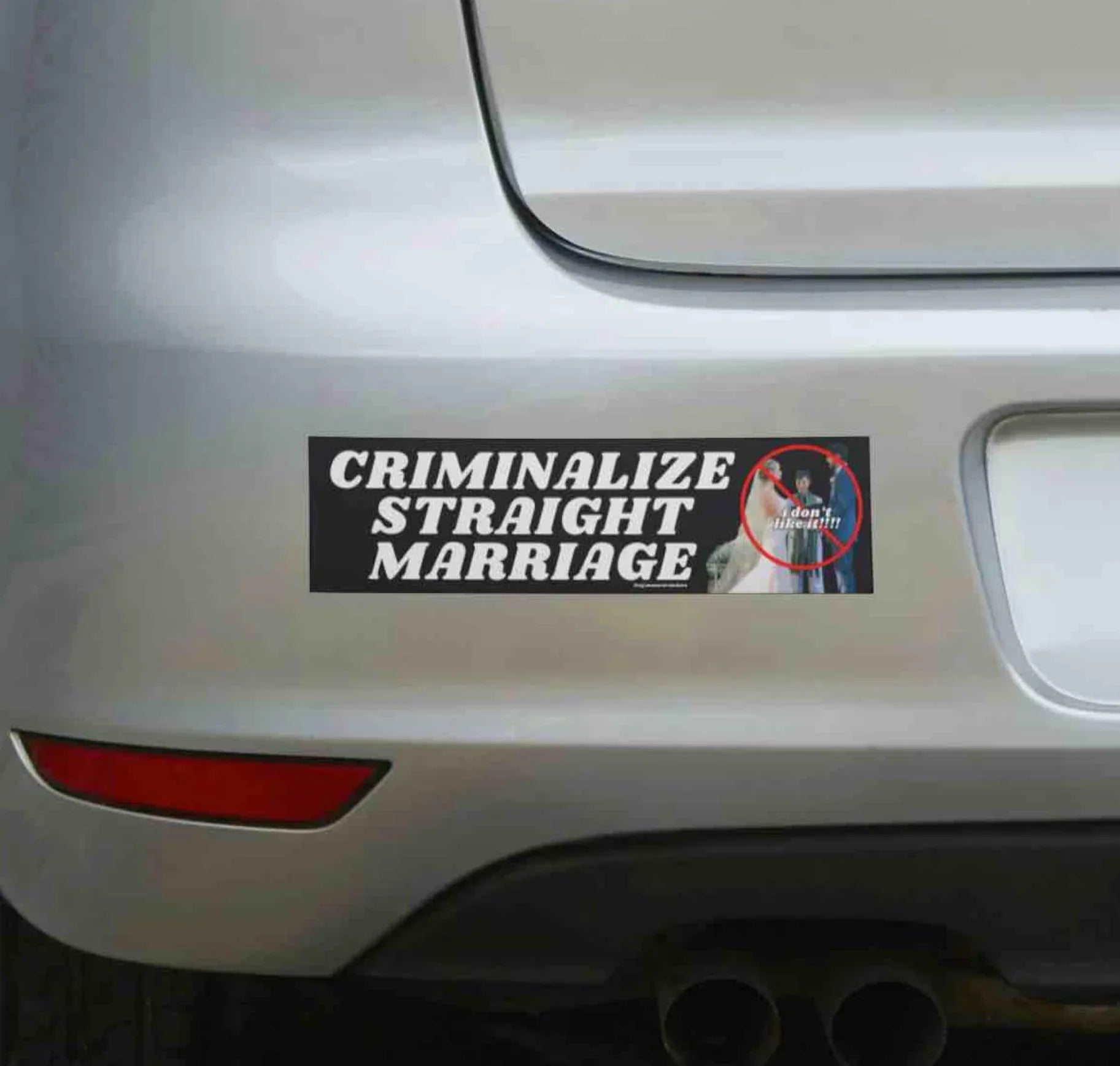 Funny weatherproof bumper sticker with 'Criminalize Straight Marriage' on a silver car.