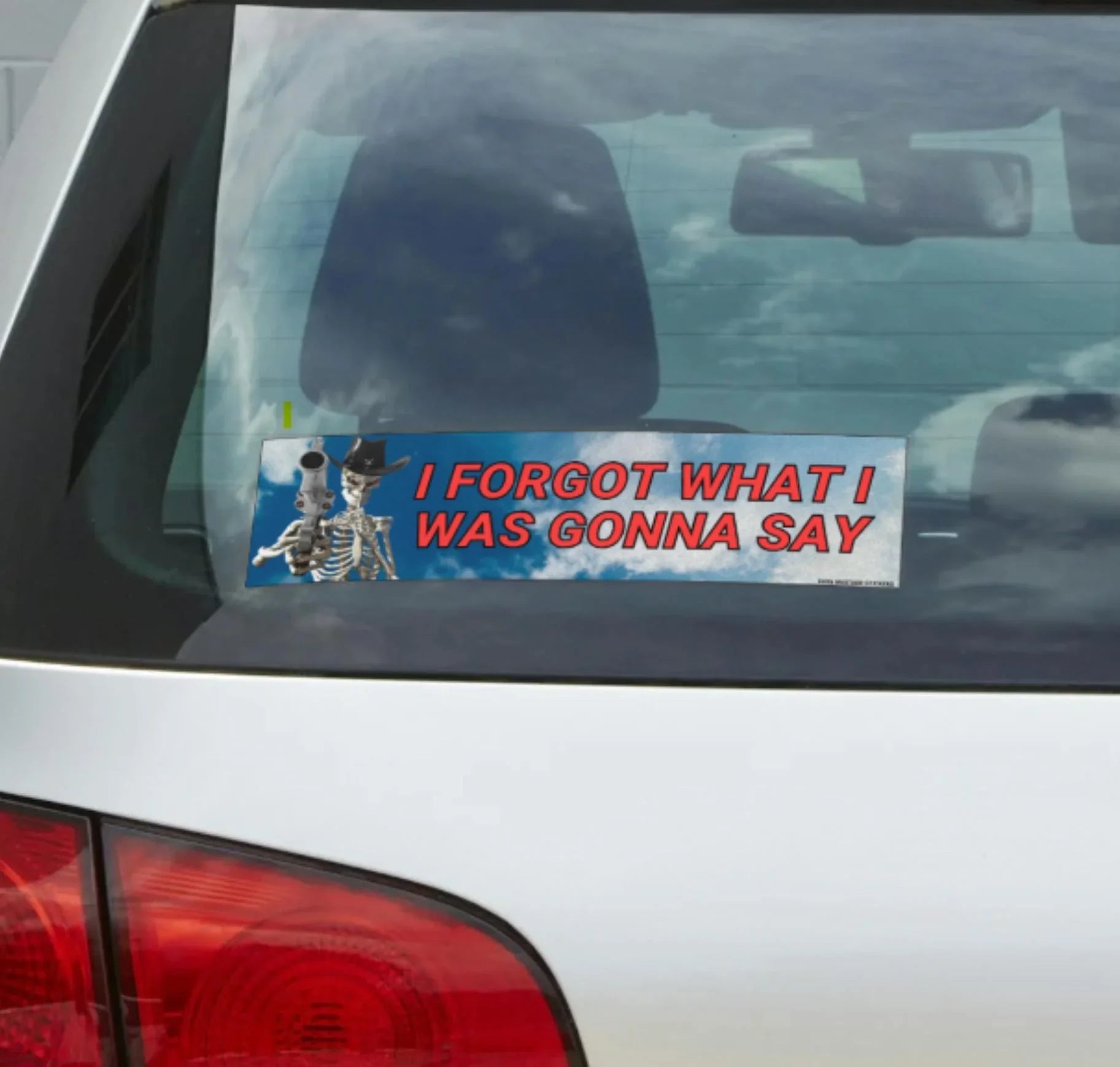Funny weatherproof vinyl bumper sticker on car with cowboy skeletons and red text 'I forgot what I was gonna say'.