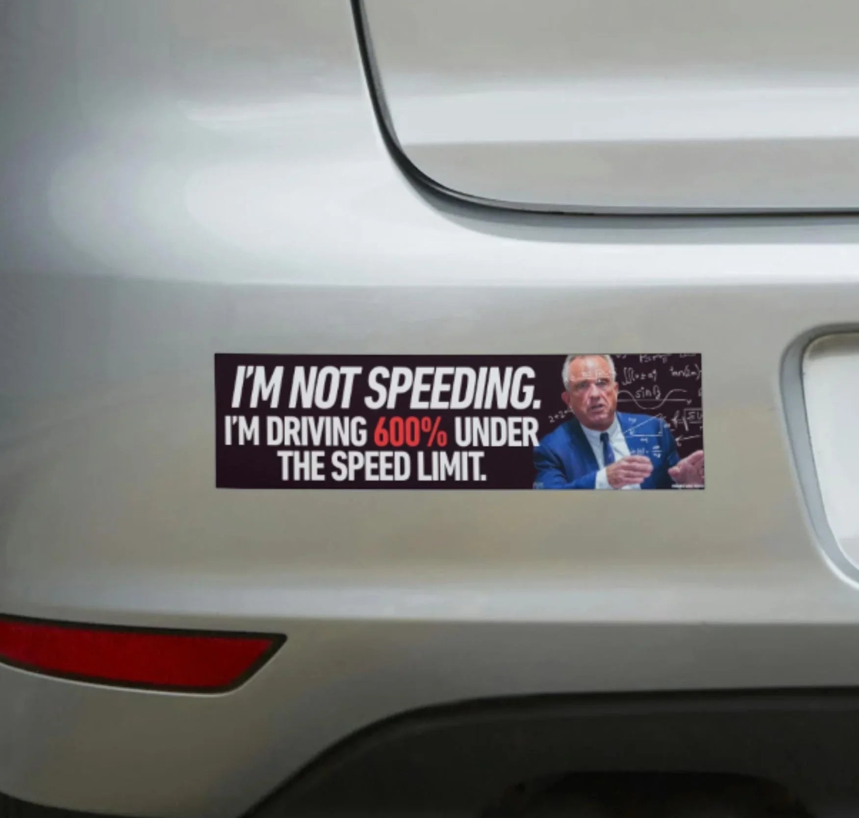 Funny bumper sticker on car with text 'I’m not speeding. I’m driving 600% under the speed limit.'