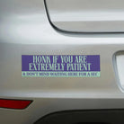 Purple bumper sticker reading 'Honk if you are extremely patient & don't mind waiting here for a sec' on car