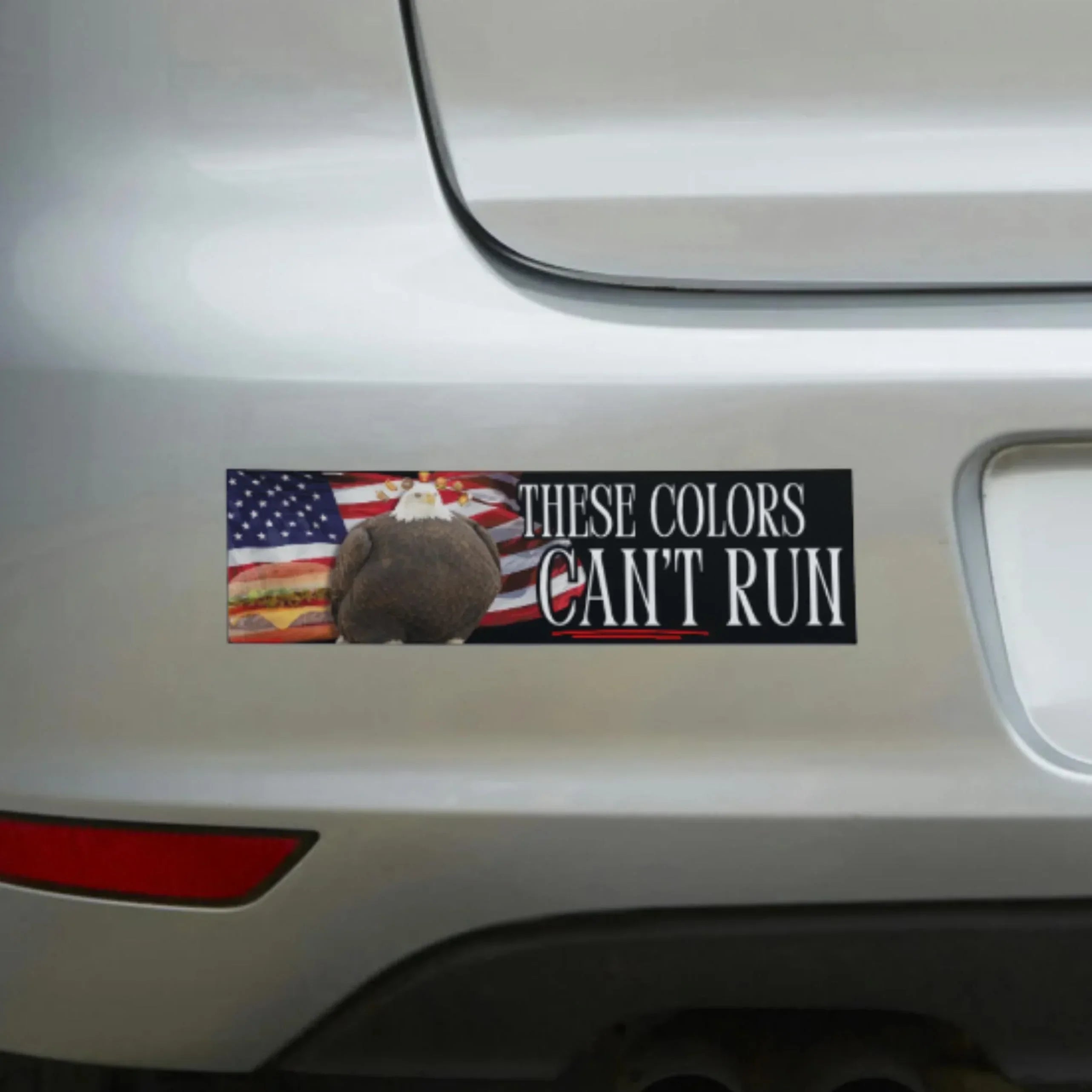 Bumper sticker with eagle, American flag, and 'These Colors Can't Run' text on car