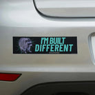 Raccoon bumper sticker with 'I'm Built Different (incorrectly)' text on car